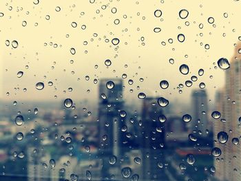 Full frame shot of wet glass window during rainy season