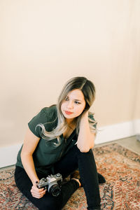 Portrait of young woman sitting at home