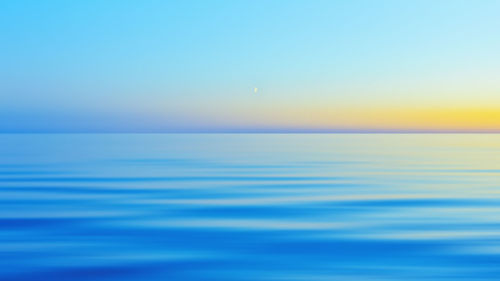 Scenic view of sea against clear sky during sunset