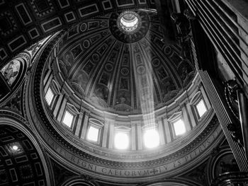 Light inside the cupola of st. peters basilica in rome.