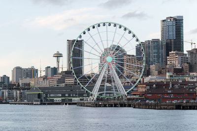 Ferris wheel in city against sky