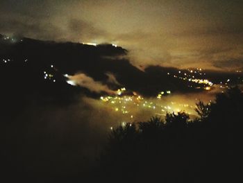 Silhouette of tree against cloudy sky