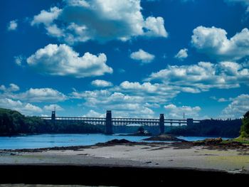 View of bridge over sea against cloudy sky