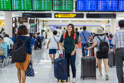 Group of people walking on airport