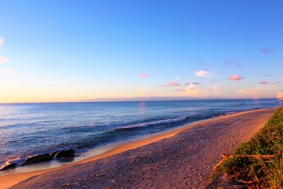 Scenic view of beach against sky during sunset