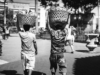 Rear view of boys standing outdoors