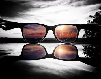 Close-up of sunglasses against sky