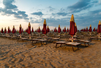 Chairs at beach against sky