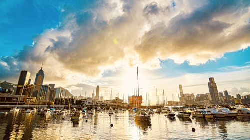 Panoramic view of harbor and buildings against sky