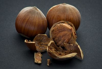 Close-up of fruits on table against black background