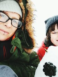 Close-up portrait of happy woman in snow