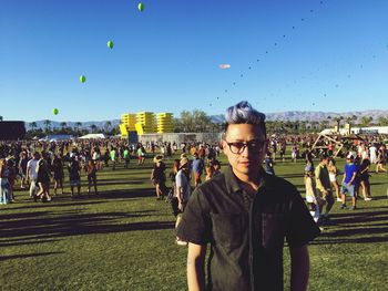 Portrait of man standing in park during coachella valley music and arts festival