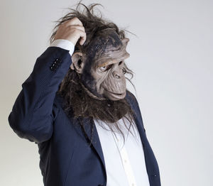 Man with monkey mask against white background