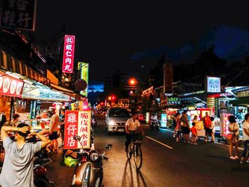 People on city street at night