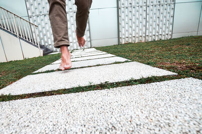 Low section of person running on footpath