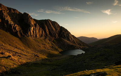 Scenic view of rocky mountains against sky during sunset