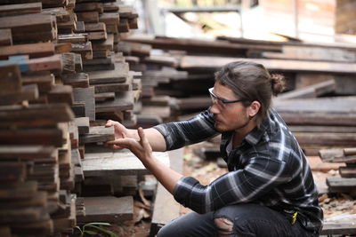 Side view of a man working in stack of building