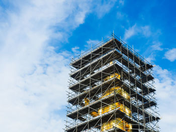 Low angle view of illuminated building against sky