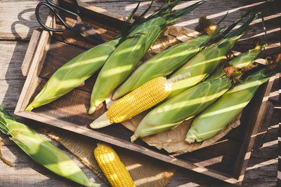 High angle view of corns in wooden container