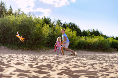 Children playing launching toy planes into the air.