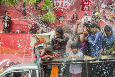 People enjoying water splash at festival