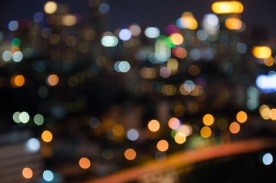 Defocused image of illuminated city at night