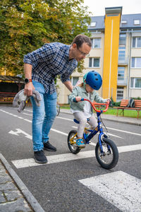 High angle view of boy riding push scooter on street