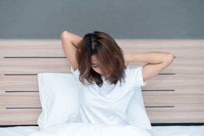 Woman sitting on bed