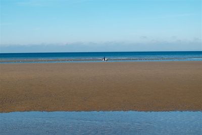 View of beach against blue sky