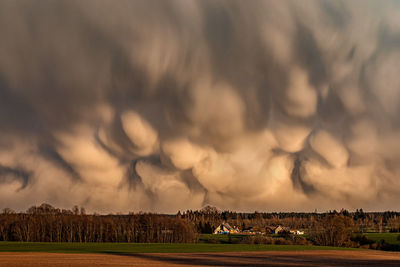 Scenic view of agricultural field against sky with mammatus clouds