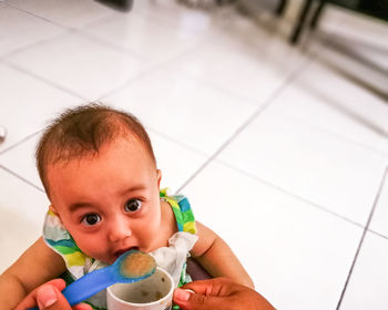 Close-up of cute portrait of baby eating food