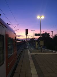 Railroad station against clear sky at sunset