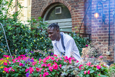 Rear view of man working on flowering plants