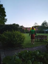 Rear view of man and woman walking against sky