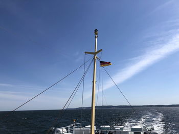 Sailboat on sea against blue sky