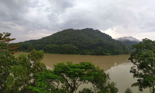 Scenic view of lake and mountains against sky