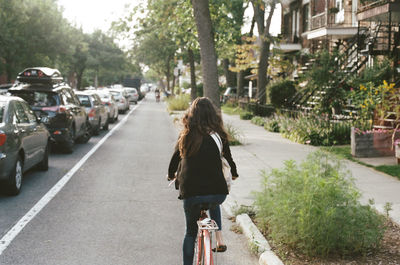 Woman walking on road in city