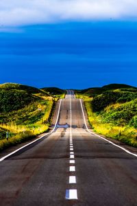 Road amidst land against sky