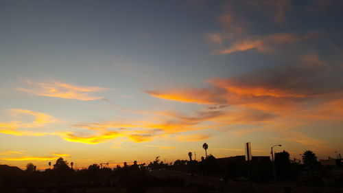 Silhouette landscape against scenic sky