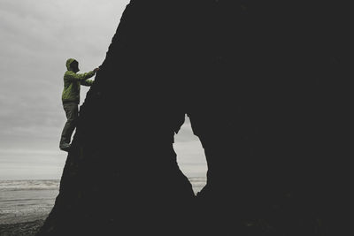 Male climber on rock formation near ruby beach washington