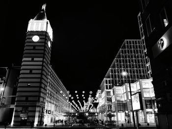 Low angle view of illuminated skyscraper against sky at night