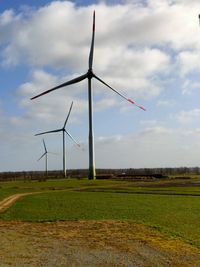 Windmill on field against sky