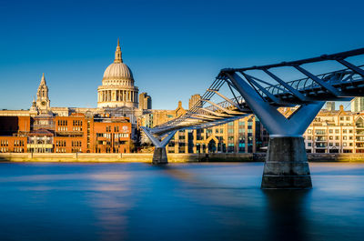 View of bridge over river against blue sky