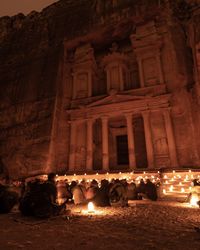 Group of people in front of temple at night