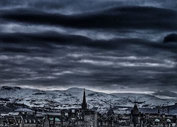 View of cityscape against dramatic sky