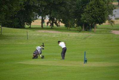 Rear view of man playing golf