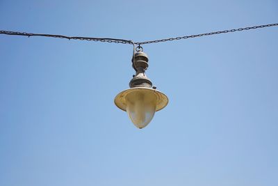 Low angle view of light bulb against clear sky