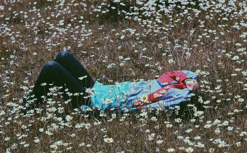 Woman lying on field