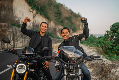 Portrait of man riding motorcycle on road