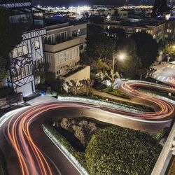 Light trails on curved road in city at night
